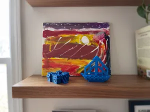 Elementary school artwork and 3D printed designs by my son, four years apart