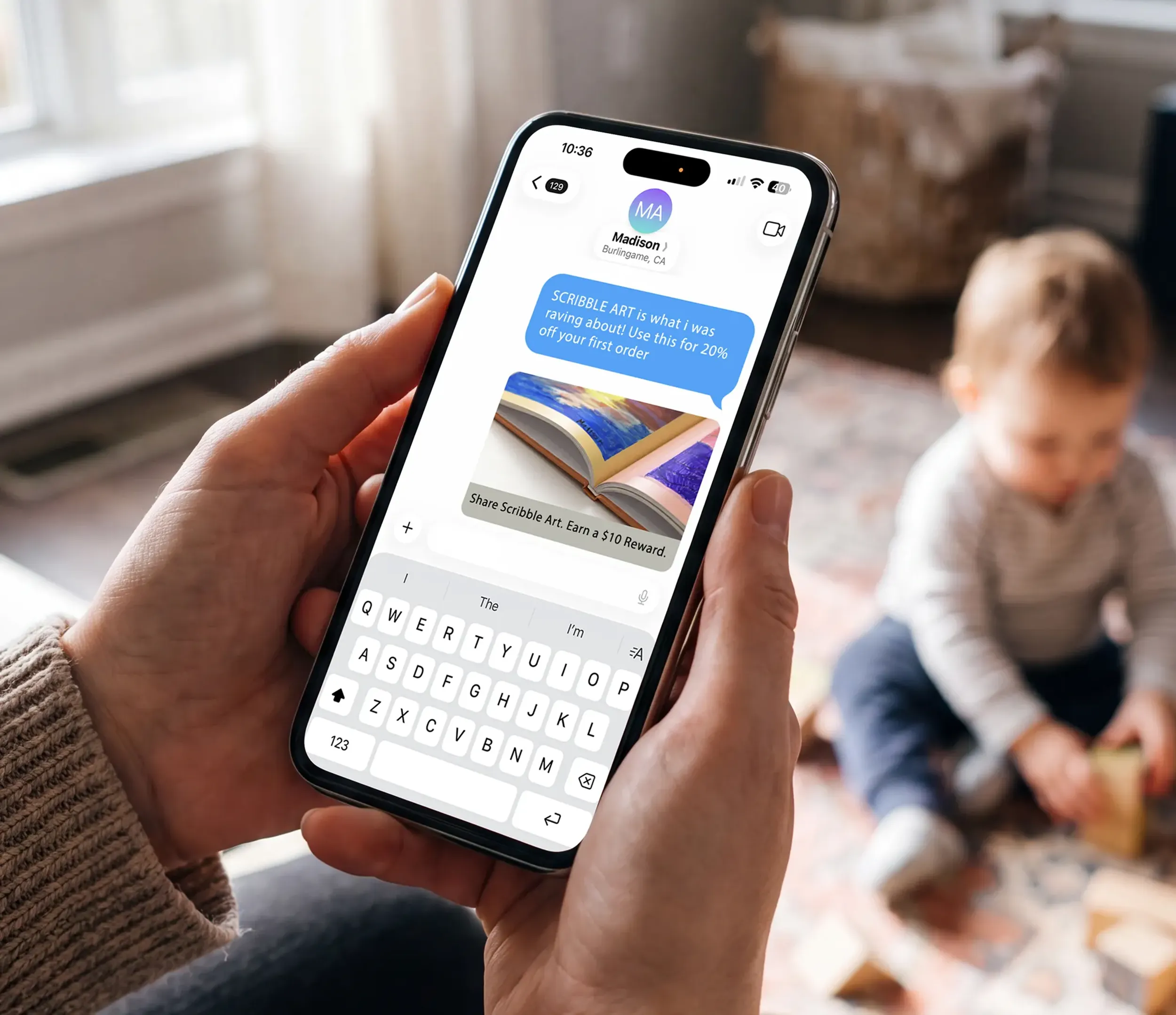 Parent sharing a Scribble Art referral link by text message