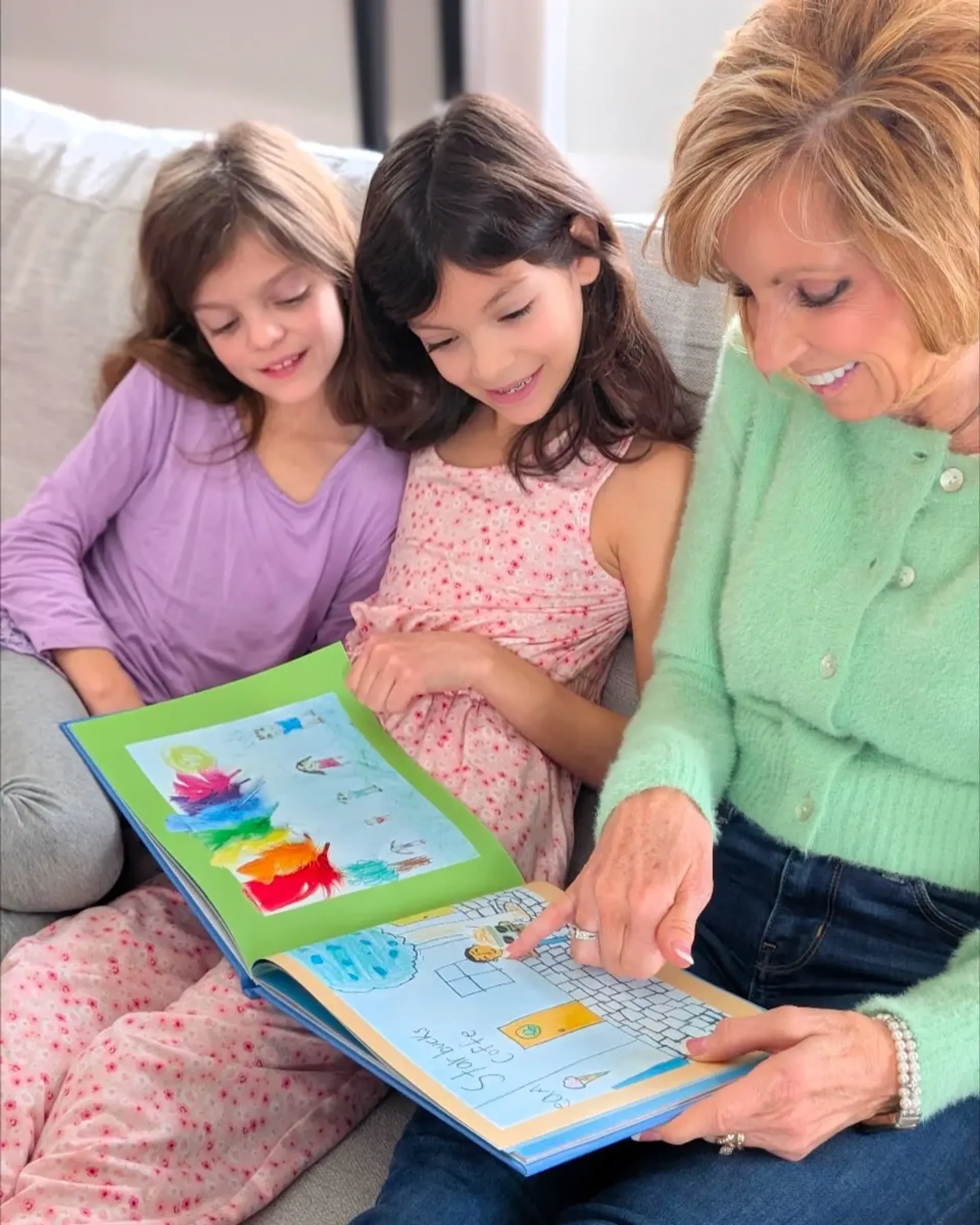 A grandmother and her proud grandchild admiring their Scribble Art book
