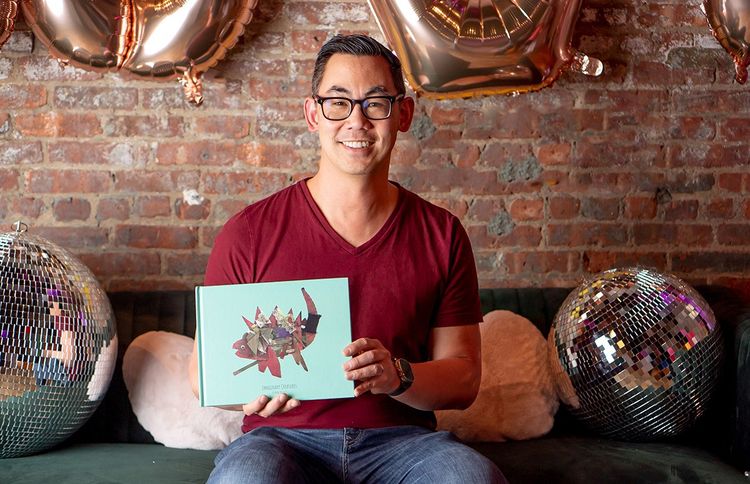 Steve Au, founder of Scribble holding up a Scribble Art book