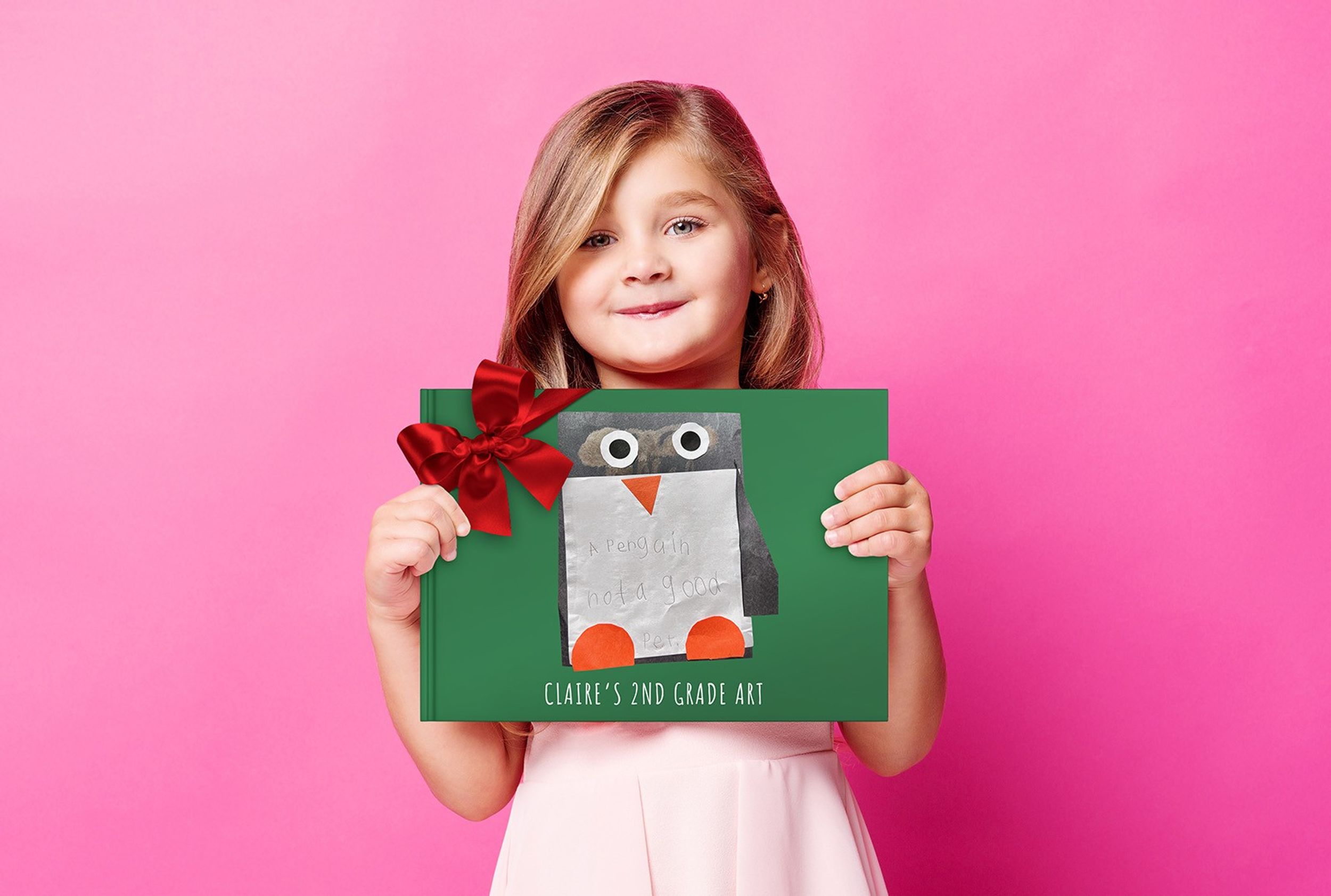 A girl holding her own book of her artwork and drawings to be gifted to her grandparents for the holidays.