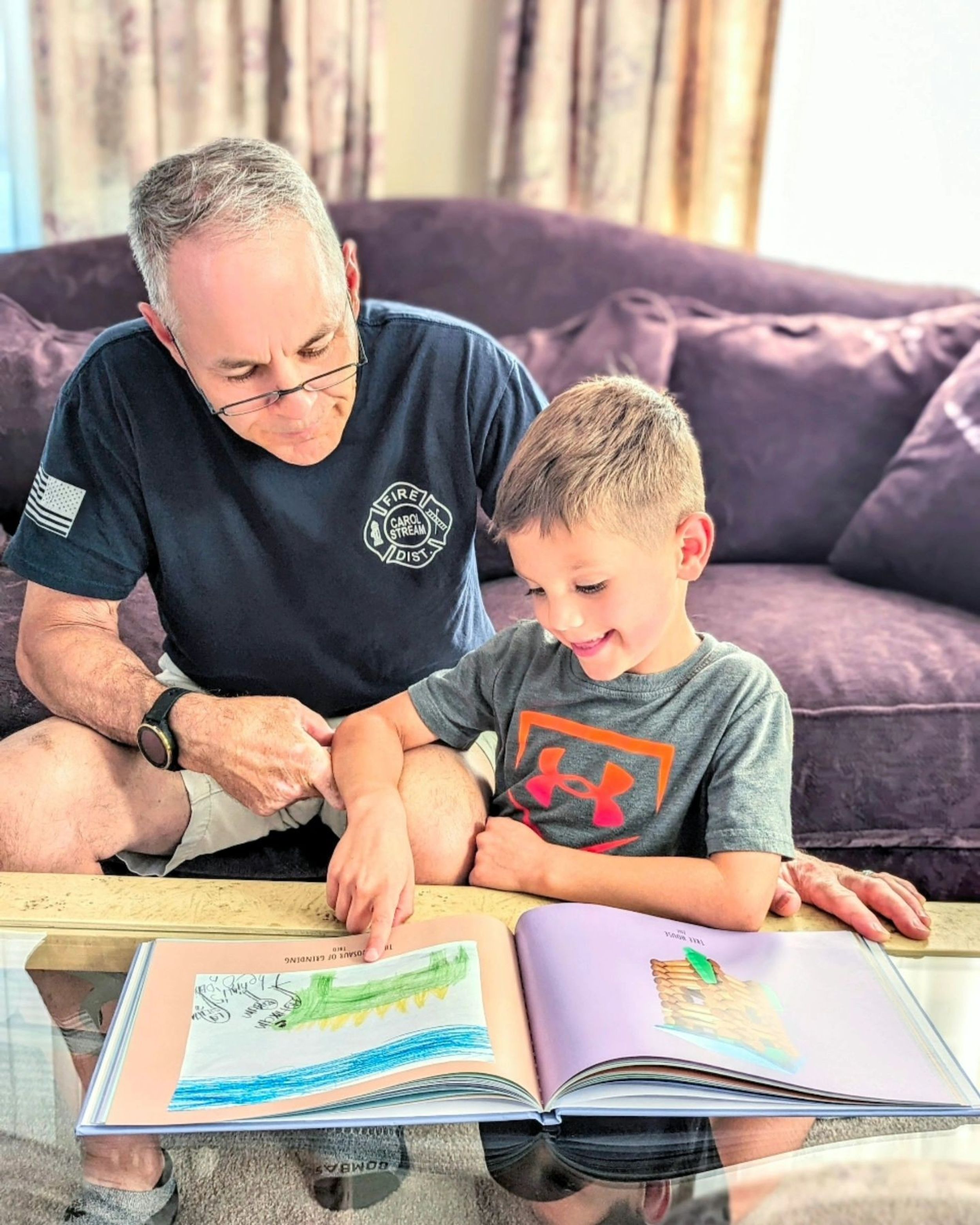 Child proudly showing their Scribble Art book