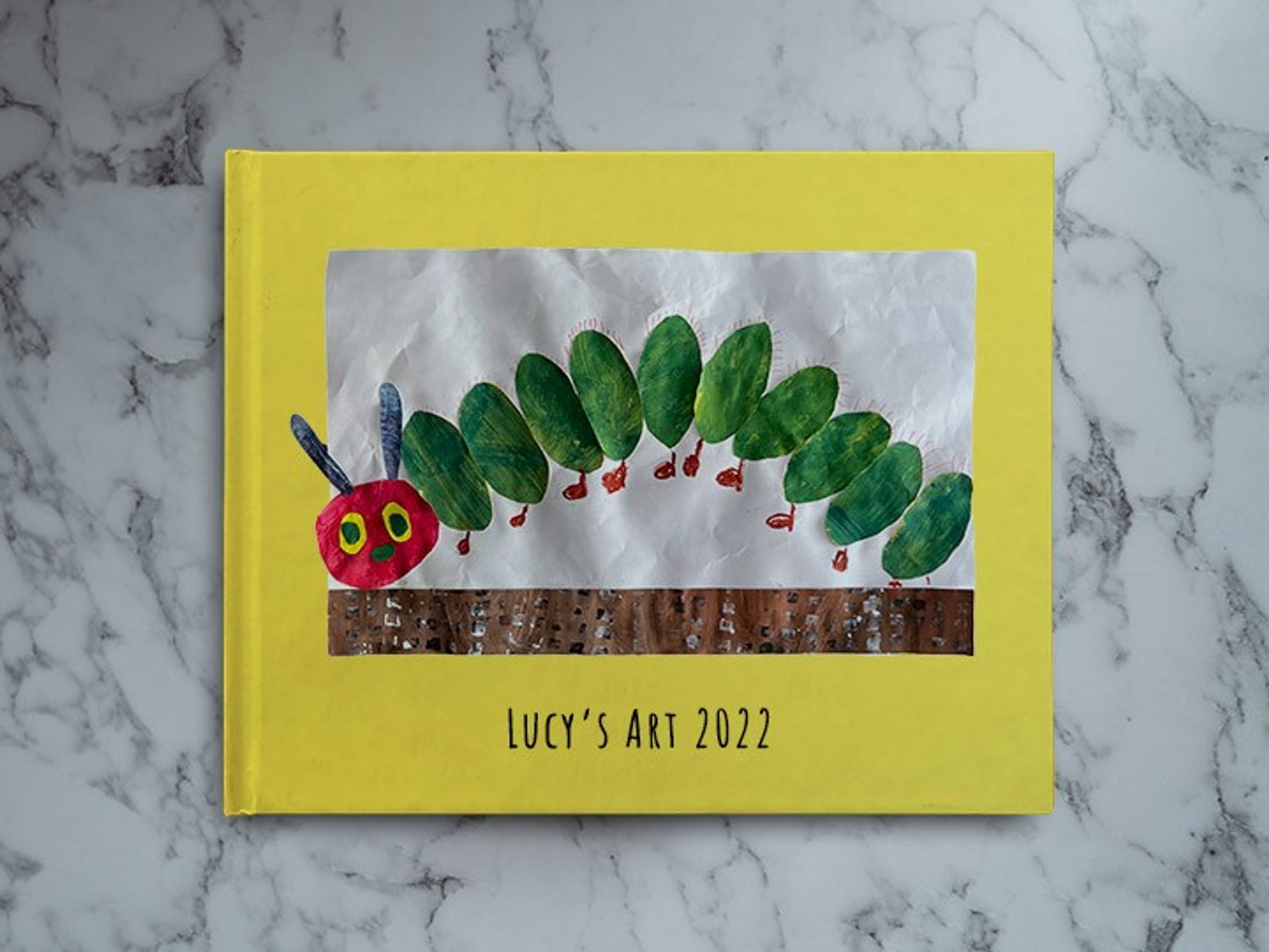 Thumbnail: An 11"x8.5" custom hardcover Scribble book of kids' artwork